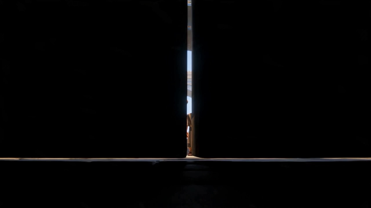Darkness — then a thin blade of light as the great gates part