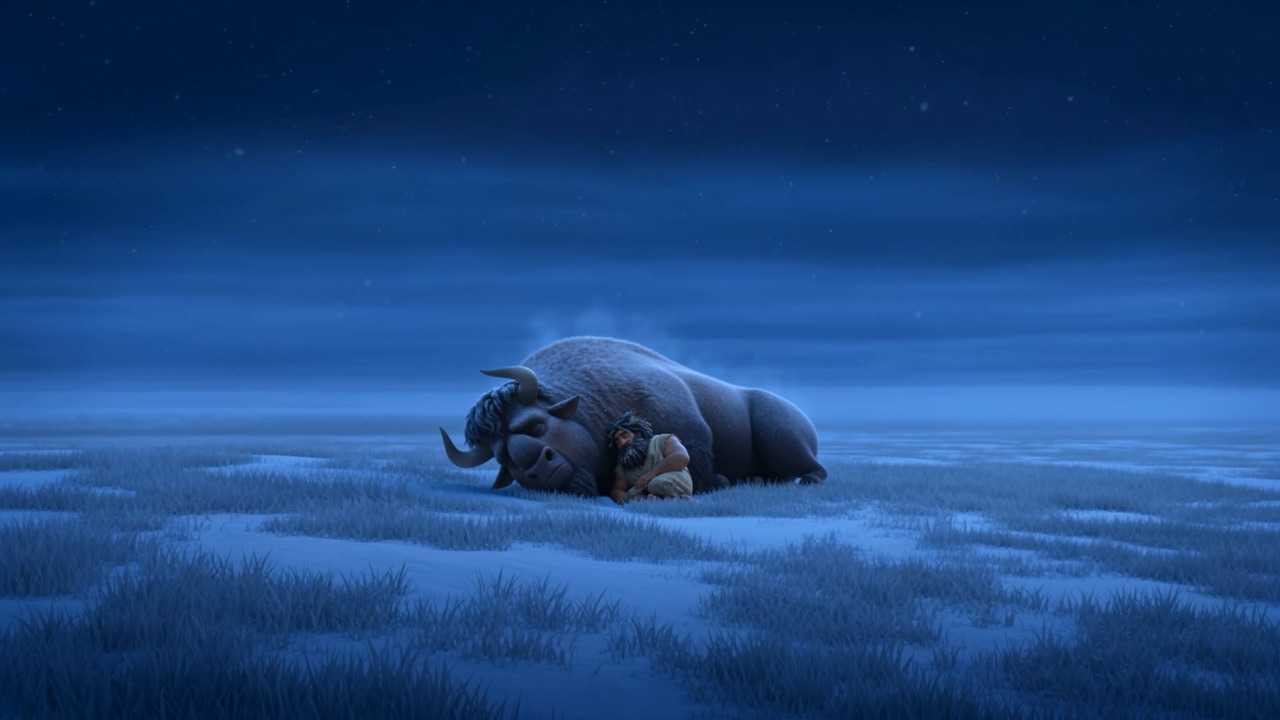 At night he sleeps curled against a sleeping ox