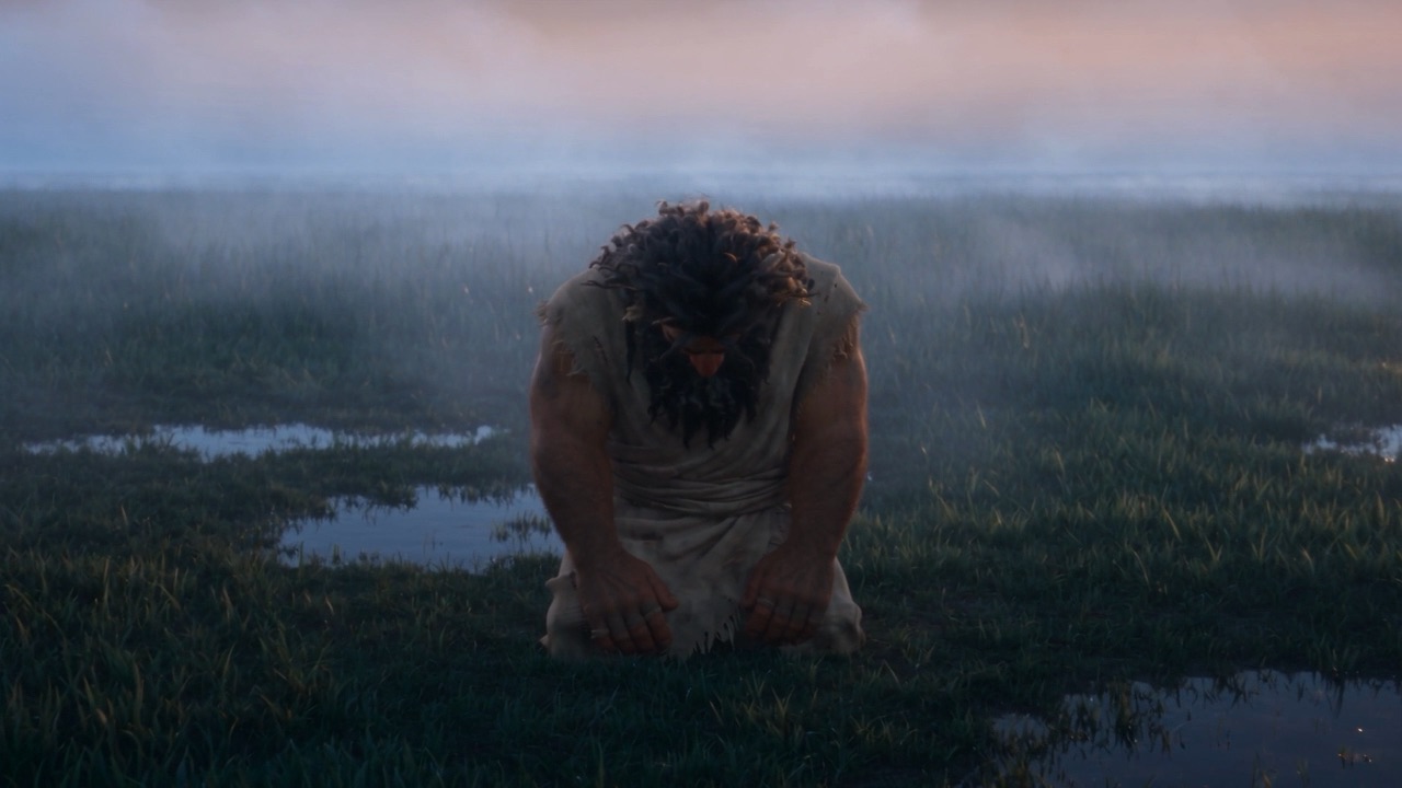 Bowed in the wet grass, he goes still
