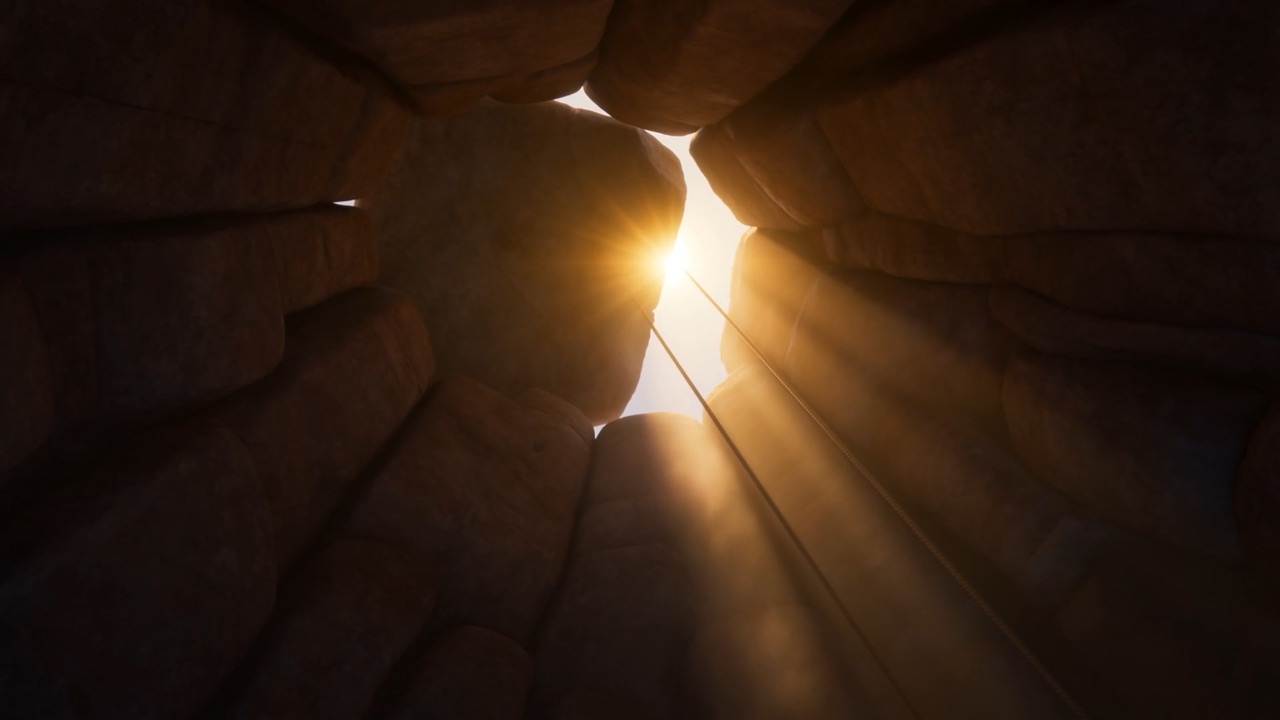 The stone slides off — sunrise pours into the den