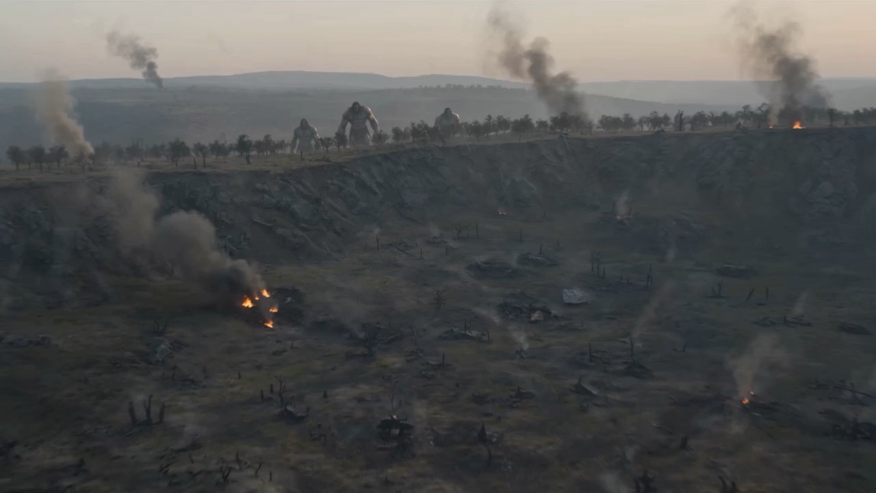 Giants march across a ravaged horizon trailing smoke