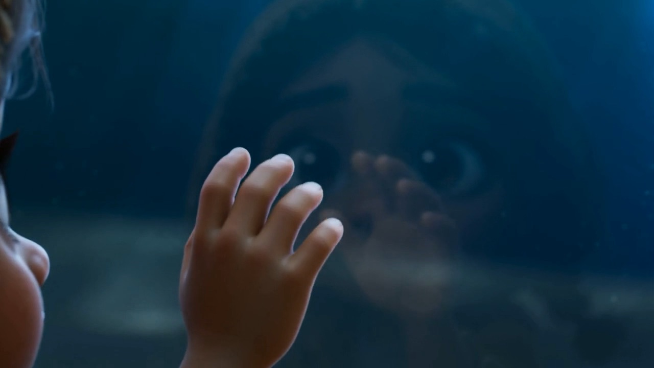 A small hand goes up against the water
