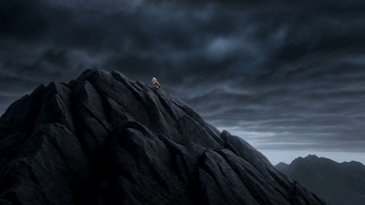 He stands at the summit in the storm and speaks