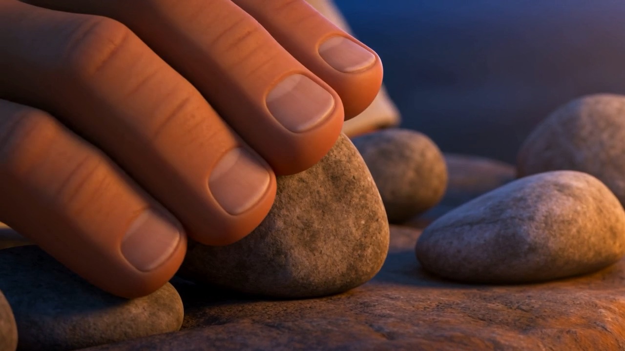 Hands setting a stone into place