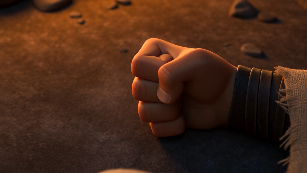 A clenched fist resting on the rock