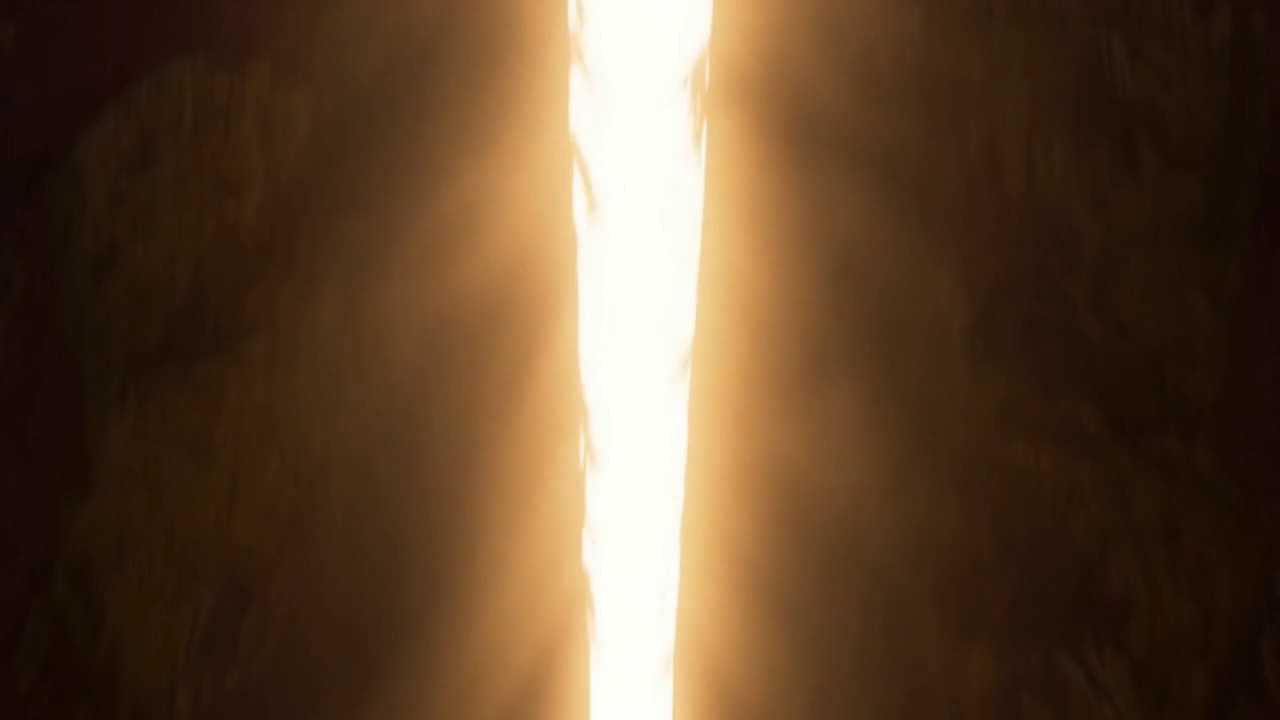 A seam of white fire opens down the middle of it