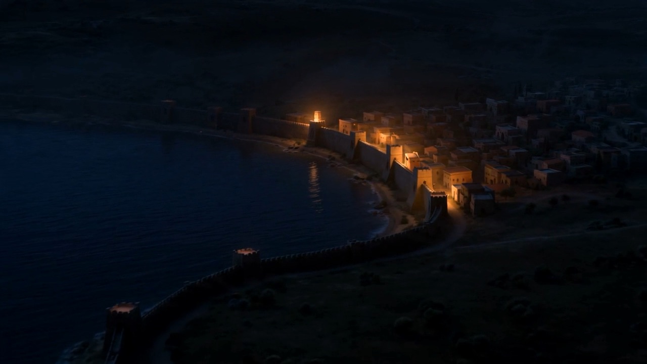 A harbour town, burning gold in the dark