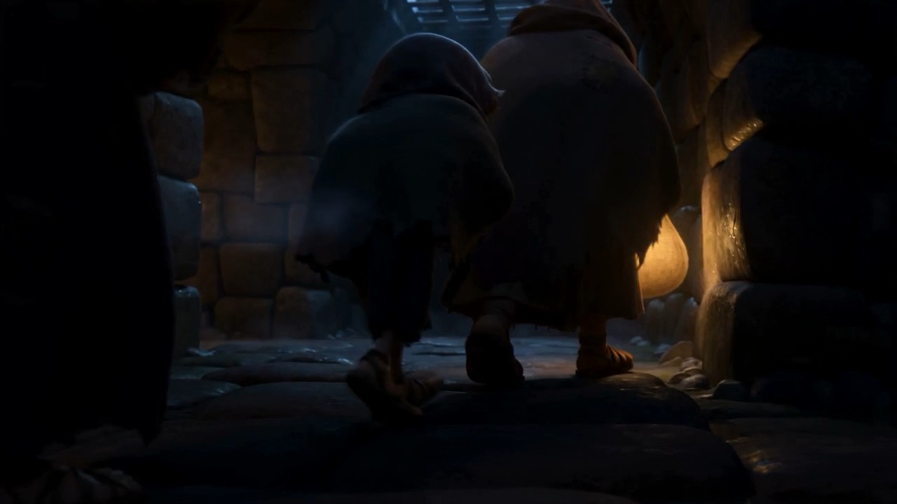 Two people crouched against a wall