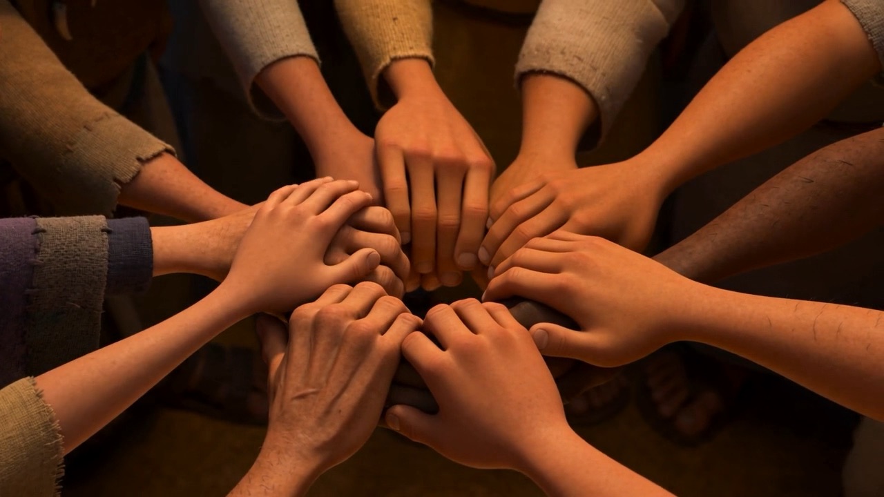 A dozen pairs of hands reach sideways and link, until the circle closes