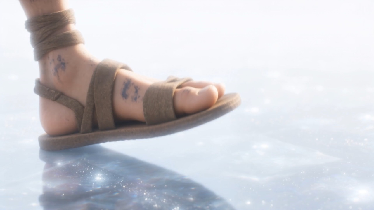 A sandal sets down, soft as a thought, on a floor of cloud and star-glass