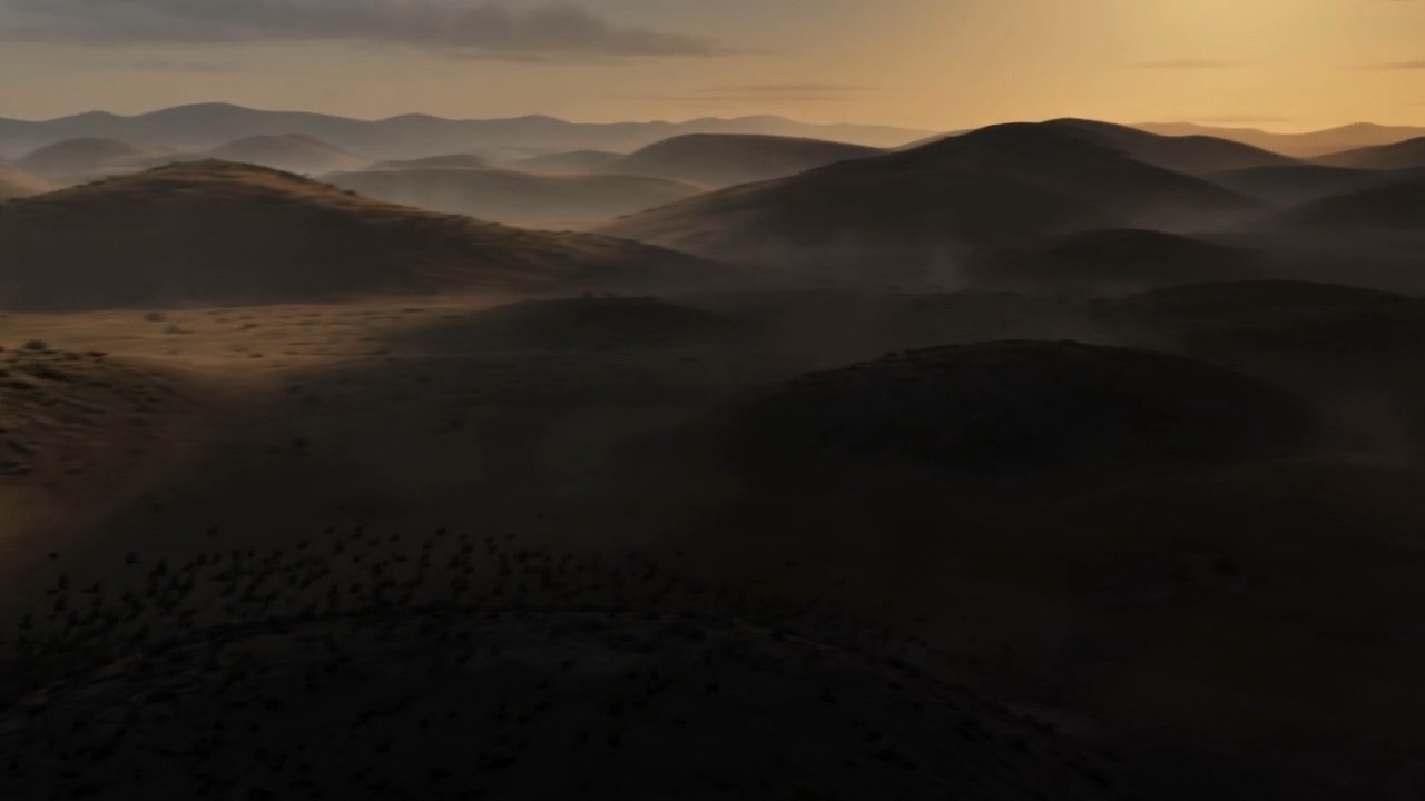 Its shadow rolls out over the hills, birds fleeing before the edge of it