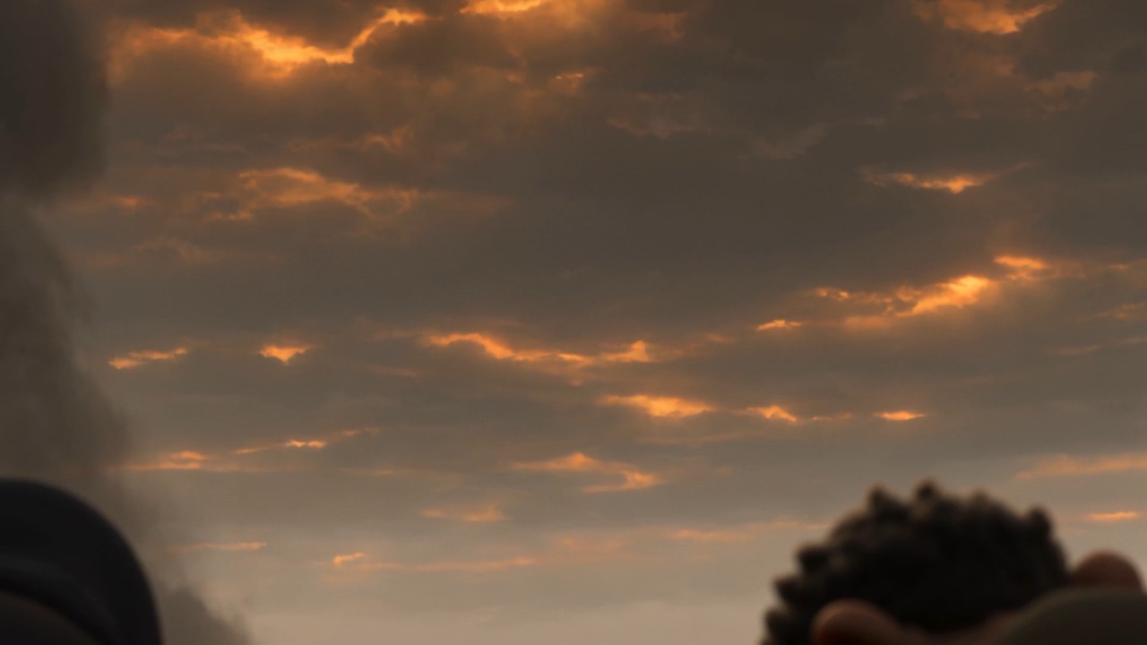 And above them the real sky is burning, ember on ember