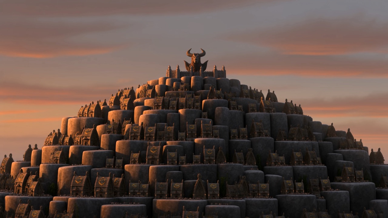 The capital of the beast at last light, climbing in terraces to its own grim crown