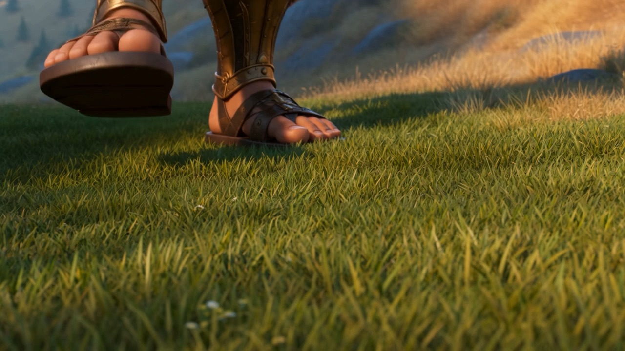 A giant's armored foot lands beside a terrified shield-bearer