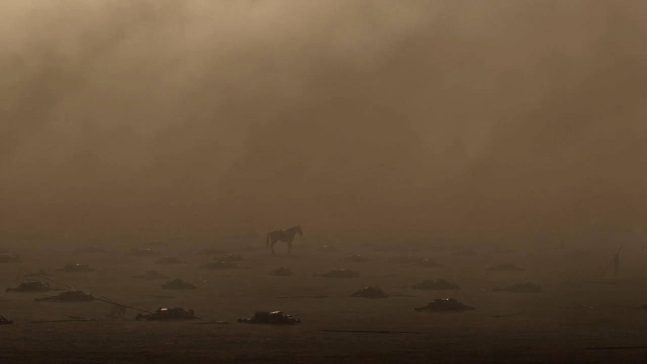 Mist drifts over the empty battlefield
