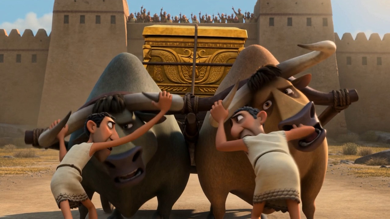 Two men strain against the ox beneath the city wall