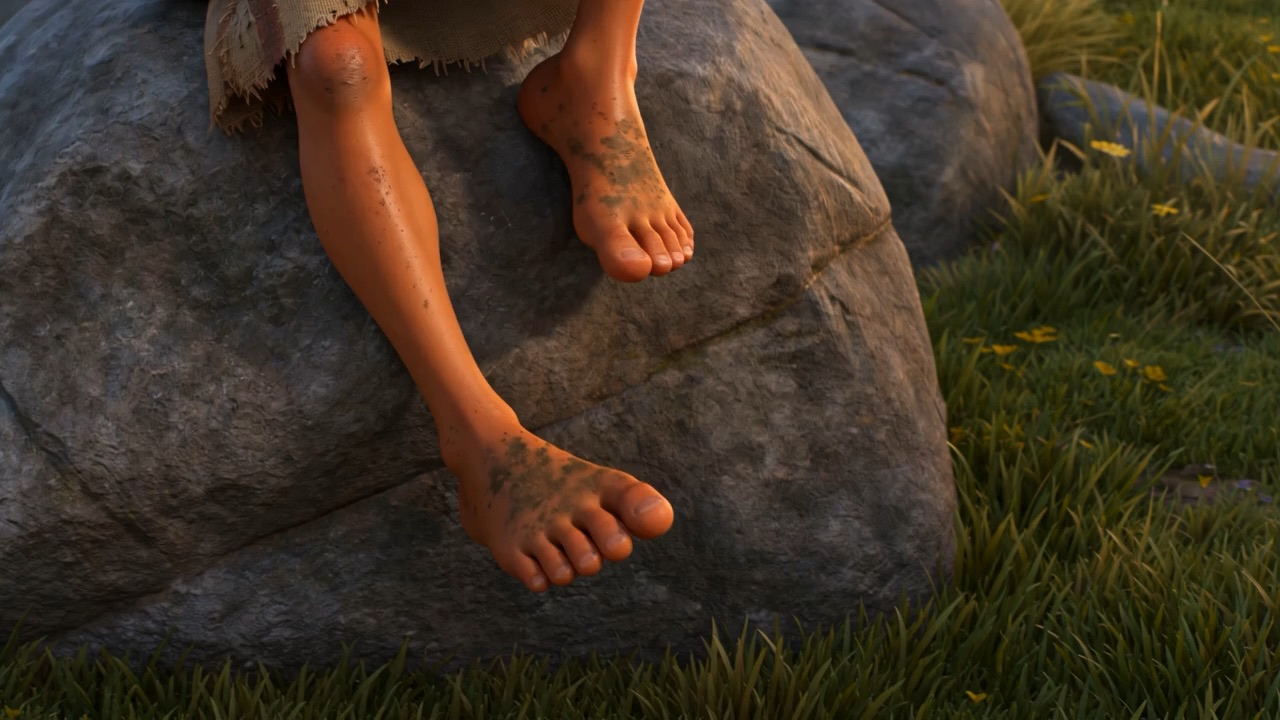 Bare feet dangling off a boulder, keeping time